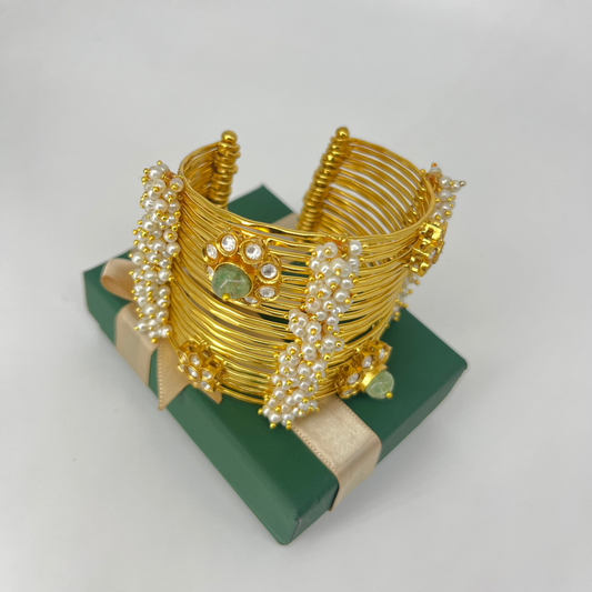 Golden bangle with bunch of pearls