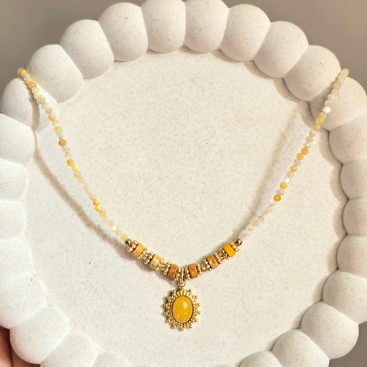 Yellow Beaded Necklace with Sunburst Oval Pendant.