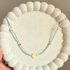 Sky Blue Beaded Necklace with Floral Charm and Pearl Accent.