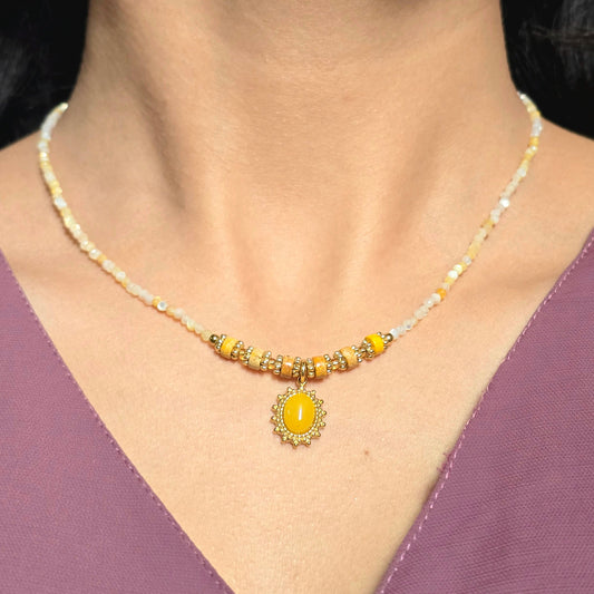 Yellow Beaded Necklace with Sunburst Oval Pendant.